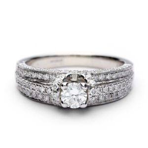 18ct white gold pavé halo engagement ring with round brilliant centre diamond and pavé-set shoulders.