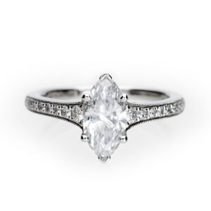 Platinum engagement ring with a 1.00ct marquise diamond and milgrain-set diamond shoulders.